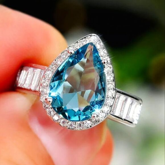 Pear Cut Blue Sapphire Flanked By White Baguette Diamonds on 925 Sterling Silver - Picture 1 of 8